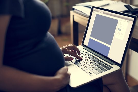 Pregnant woman is using computer laptop