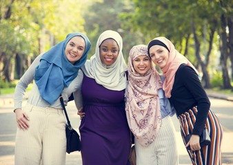 Group of islamic friends embracing and smiling together - obrazy, fototapety, plakaty