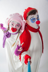 emotional mime guy and girl take pictures of themselves on the phone. Human emotions
