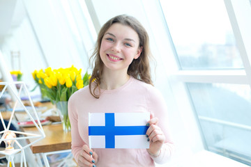 Young woman with the flag of Finland.