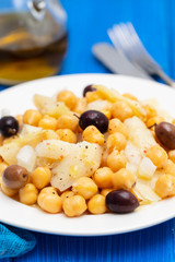 cod fish with chick pea and olives on dish