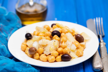 cod fish with chick pea and olives on dish