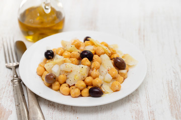 cod fish with chick pea and olives on dish