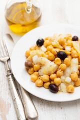 cod fish with chick pea and olives on dish