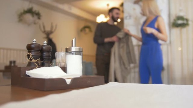 Diner Booth Condiments In Front Of Couple Entered Into A Cafe