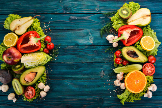 Assortment of fresh vegetables and fruits. Healthy food On a blue wooden background. Top view. Copy space.