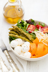 vegetables with cheese in small bowl on blue wooden background