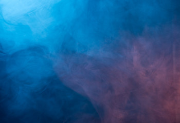 Fototapeta na wymiar Abstract blue and pink smoke on a dark background