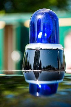 Old Style British Blue Police Light On Patrol Car Roof.