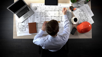 Engineer drawing plan of building, safety engineering, office location planning