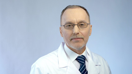 Physician smiling, posing for camera, professionalism and qualified medical care