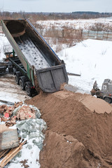 Fototapeta premium the truck pours the sand
