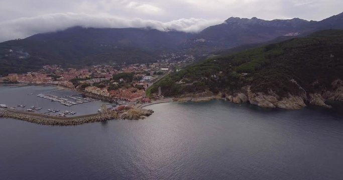 Aerial, beautiful bay and a little port of Marciana Marina on Elba island in Tuscany, Italy on a cloudy day