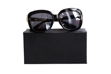 Fashionable sunglasses with box on white background