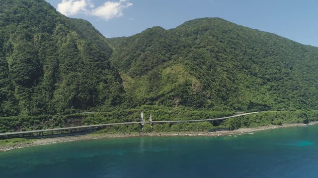 Aerial view of Patapat viaduct in the coast of Pagudpud, Ilocos Norte. Highway with bridge by coast sea near the mountains. Philippines, Luzon. Highway along the coast.