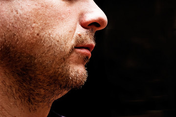 male chin on a dark background
