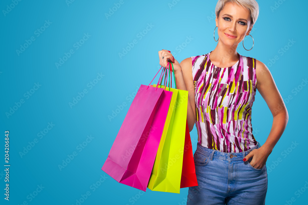 Canvas Prints shopping woman holding color bags isolated on blue background in black friday holiday. summer shoppi