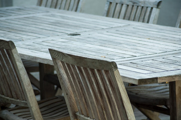 Fototapeta na wymiar closeup of Teak garden furniture on a wooden terrace in spring