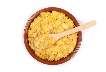 Crunchy corn flakes, cereal, muesli pile in porcelain bowl with wooden spoon isolated on white background, top view