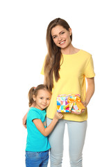 Cute little girl and her mother with gift box on white background