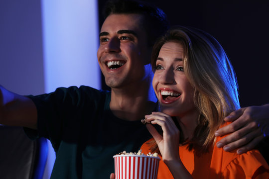 Young couple watching movie in cinema
