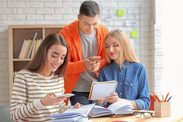 Students making cheat sheets for exam in library