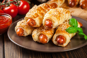Rolled hot dog sausages baked in puff pastry