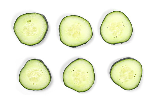 Cucumber slices isolated on white background, top view