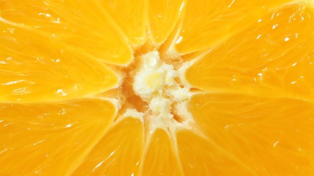 Close up of orange with falling water drops. No sound.