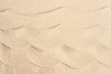 Fototapeta na wymiar Wavy sandy beach texture for summer travel background