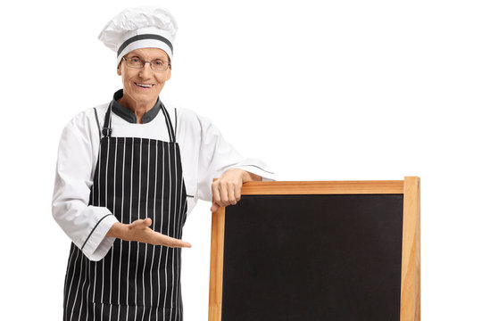 Elderly chef showing a blank blackboard