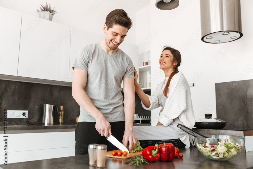 Sticker Portrait of a joyful young couple cooking together