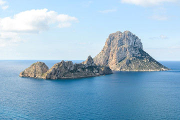 Fototapeta premium Ibiza, Spain - October 5, 2017 : Beautiful view of big stone island Es Vedra of Ibiza, Balearic islands, Spain. Sea rest and holiday concept. View from water. Popular summer resort.