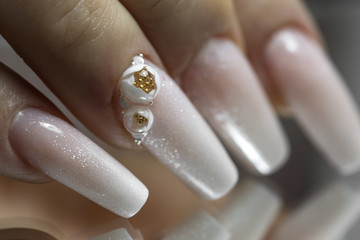 Close up of Bride's hands with simple manicure with a little jewel on the nail