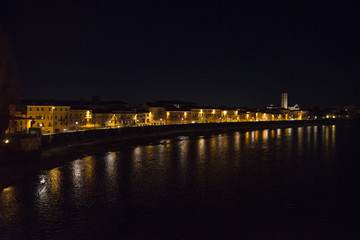 Fototapeta na wymiar cityscape on the riverside with historical buildings and towers view of Verona City. Italy