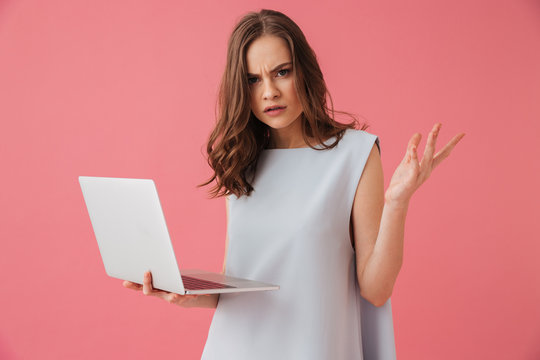 Confused Young Woman Using Laptop Computer.