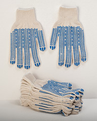 White Cotton Gloves With Blue Rubber Studs On White Background
