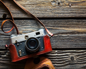 Retro camera on wood table background, vintage color tone