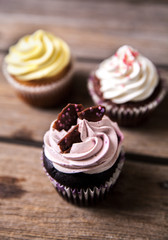 cupcakes decorated with sweet on wooden table