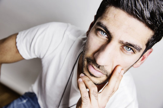 Portrait of young man with blue eyes and stubble