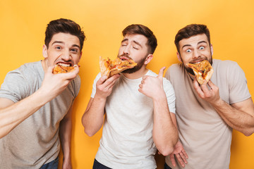Three young delighted men eating pizza