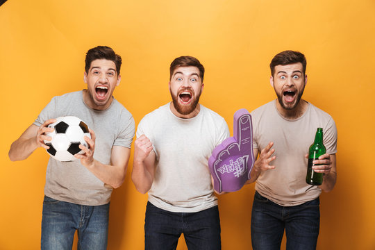 Three young happy men football fans celebrating