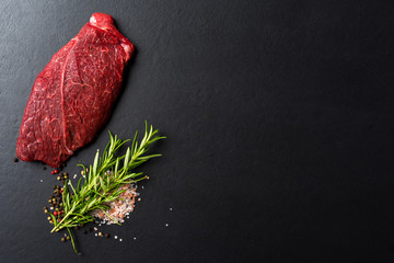 Raw beef steak with herbs and spices