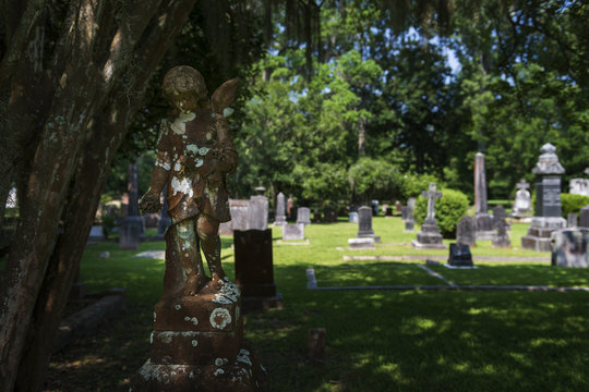 Statue of a sad angel in a cemetery in the State of Louisiana, USA.