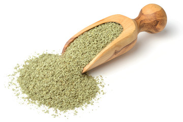 rubbed sage in the wooden scoop, isolated on white