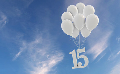 Number 15 party celebration. Number attached to a bunch of white balloons against blue sky