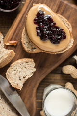 Peanut Butter and Jelly Sandwich on Rustic Wooden Background. Homemade Healthy Breakfast.