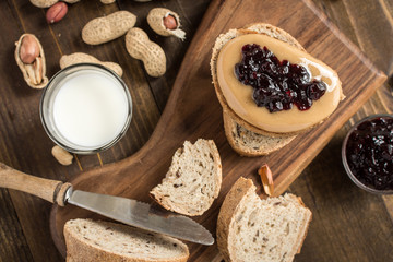 Peanut Butter and Jelly Sandwich on Rustic Wooden Background. Homemade Healthy Breakfast.
