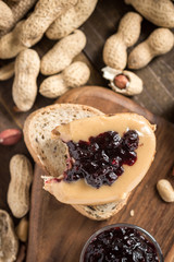 Peanut Butter and Jelly Sandwich on Rustic Wooden Background. Homemade Healthy Breakfast.