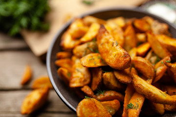Baked potato fries on wooden table